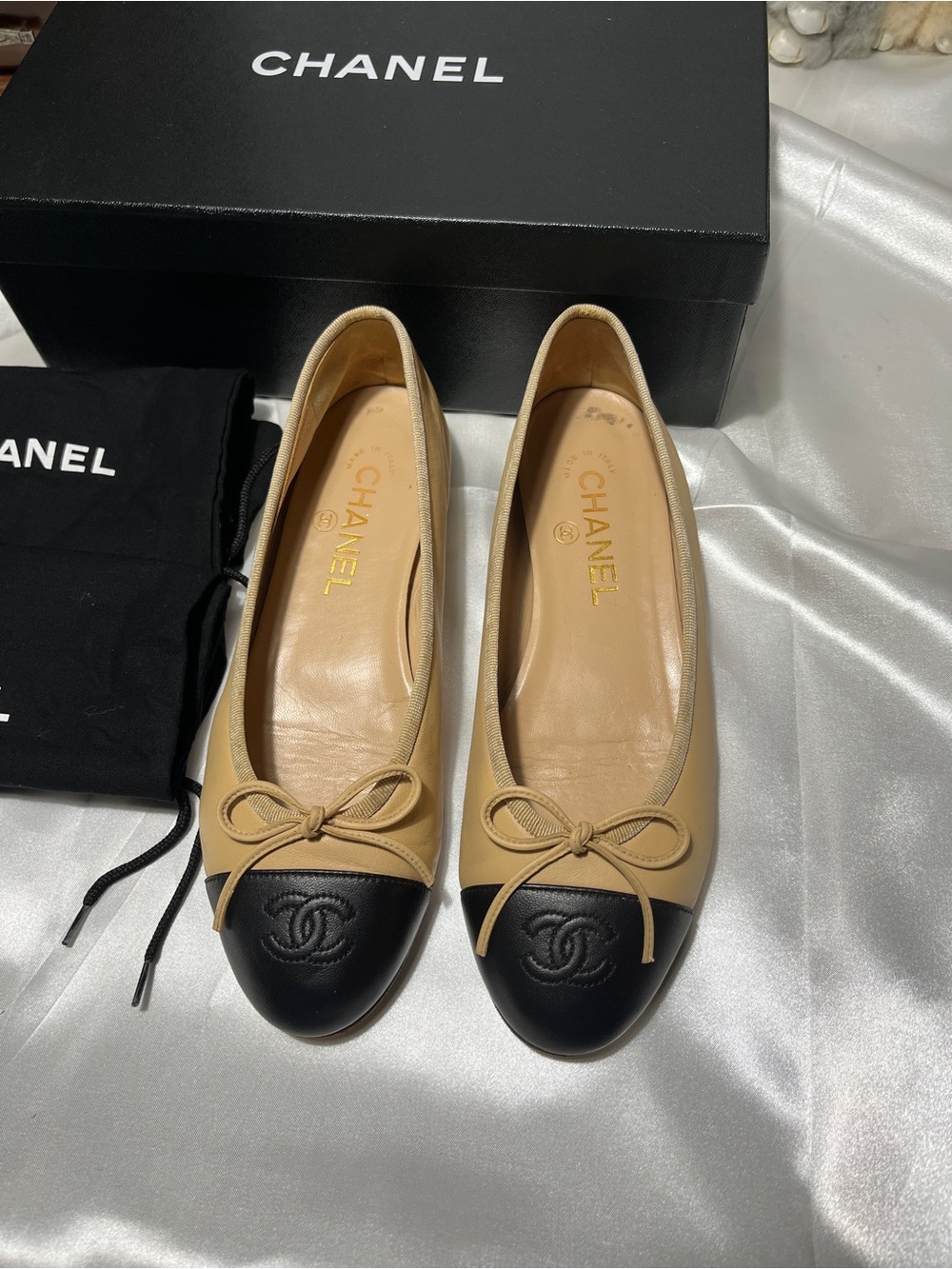 CHANEL Beige Leather Ballet Flats with Black Cap Toe and Bow